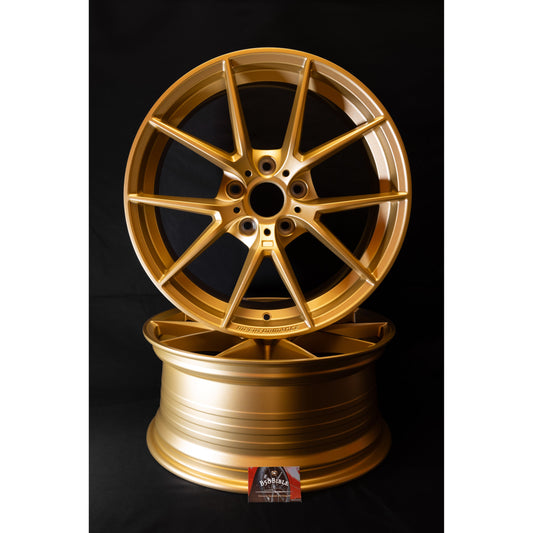 763m style alloys in satin gold for BMW F20/F21/F22 stacked on top of eachother showing the side profile and front face of both wheels